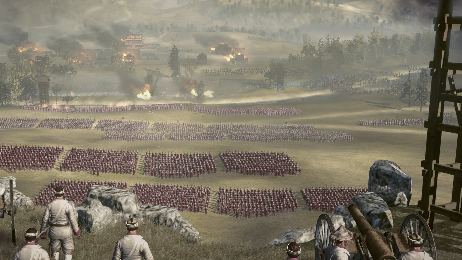 Fall of the Samurai artillery crew above massed infantry while explosions strike near a burning settlement.